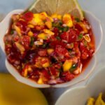 Close up of strawberry mango salsa in a bowl.