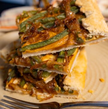 Pieces of the green bean galette stacked on top of each other.