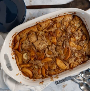 Looking straight down on a vegan peach cobbler in a serving dish.