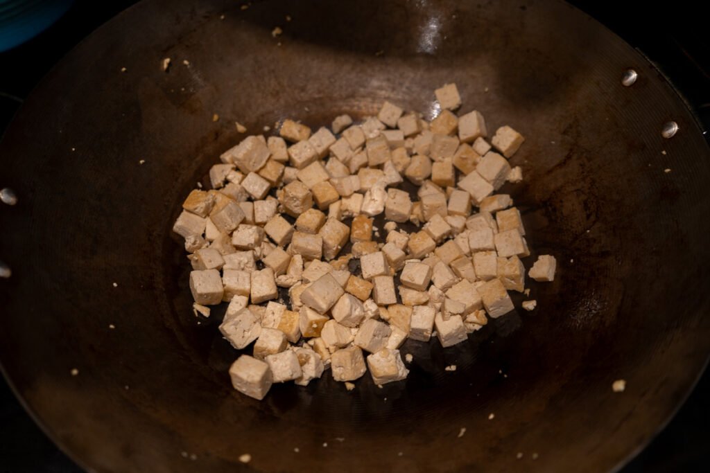 Cubed tofu in a wok