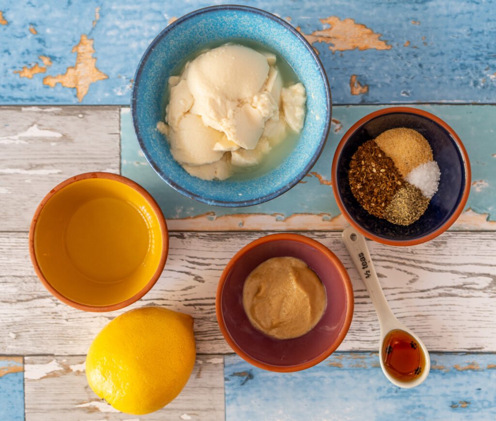 All of the ingredients for the dip in small bowls.