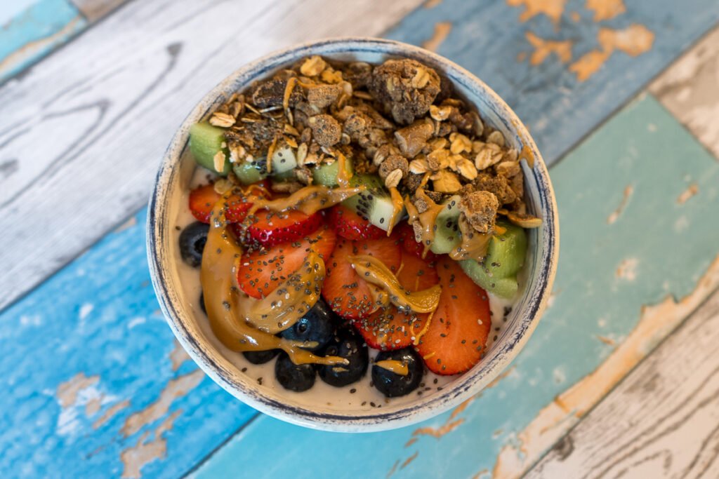 A bowl of yogurt with the fruit and granola.