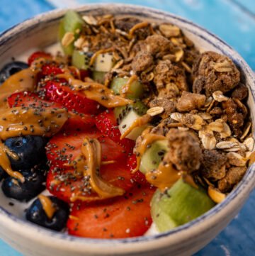 A bowl of yogurt with the fruit and granola.