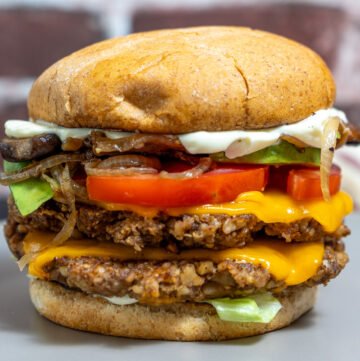 Side view of a walnut mushroom smash burger on a plate